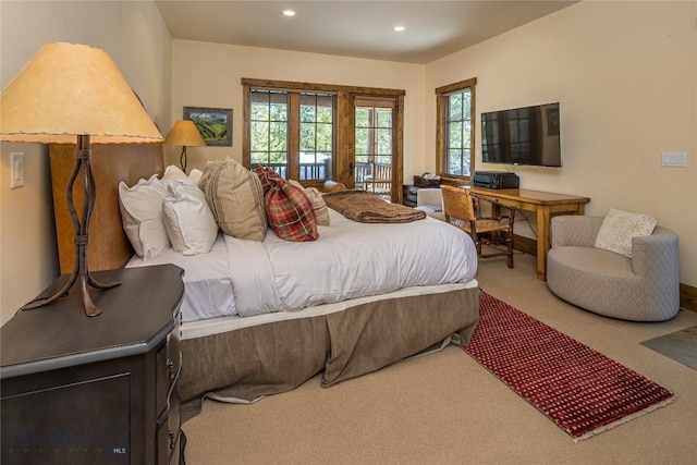 bedroom with carpet floors and access to outside