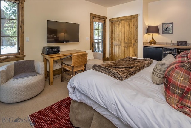 bedroom with bar, carpet flooring, and access to outside