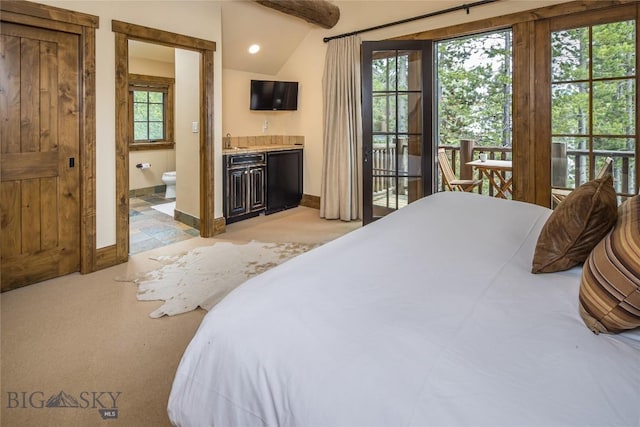 bedroom featuring refrigerator, access to exterior, indoor wet bar, ensuite bath, and lofted ceiling