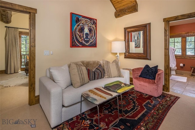 carpeted living room featuring vaulted ceiling