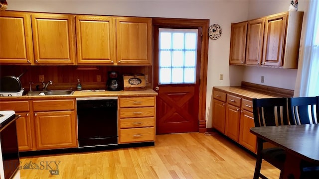 kitchen featuring white range with electric cooktop, sink, light hardwood / wood-style flooring, and dishwasher