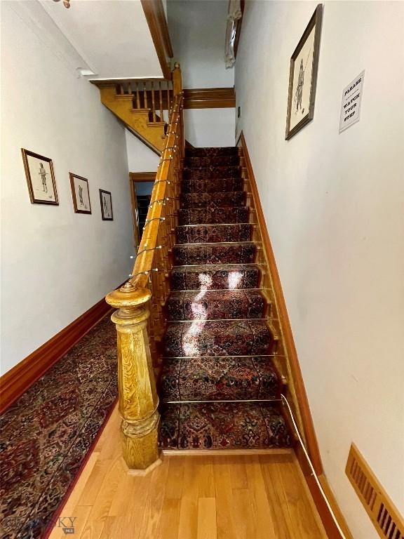 stairs featuring hardwood / wood-style flooring