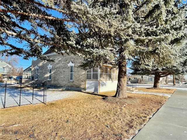 view of property exterior featuring a lawn