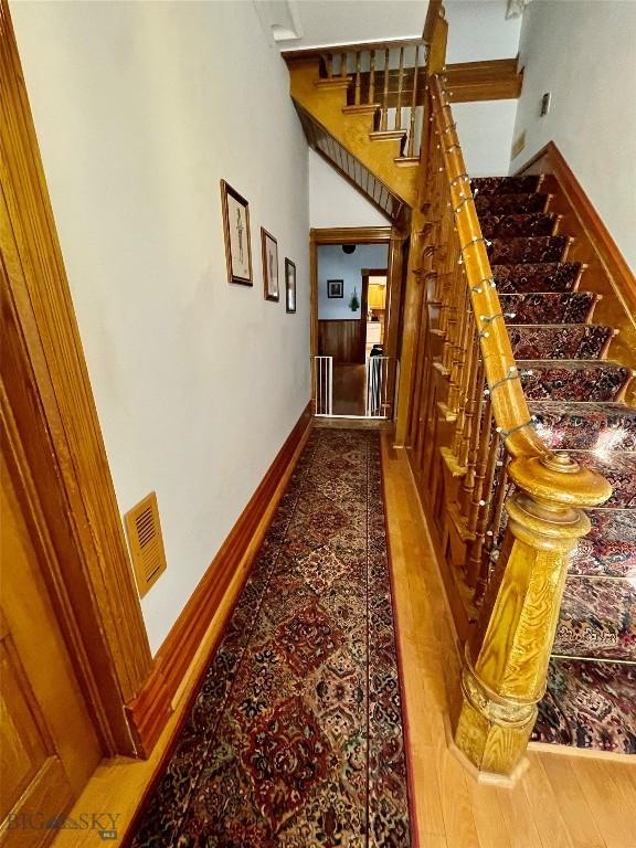 hallway with hardwood / wood-style flooring