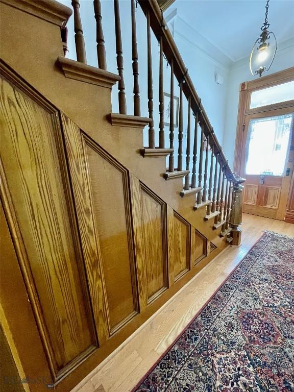 staircase featuring ornamental molding