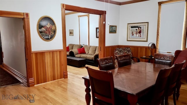 dining space with hardwood / wood-style floors and ornamental molding