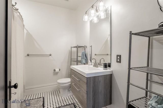 bathroom with vanity, toilet, and tile patterned flooring