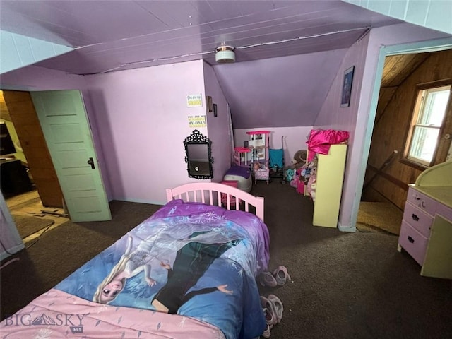 bedroom with dark carpet and vaulted ceiling