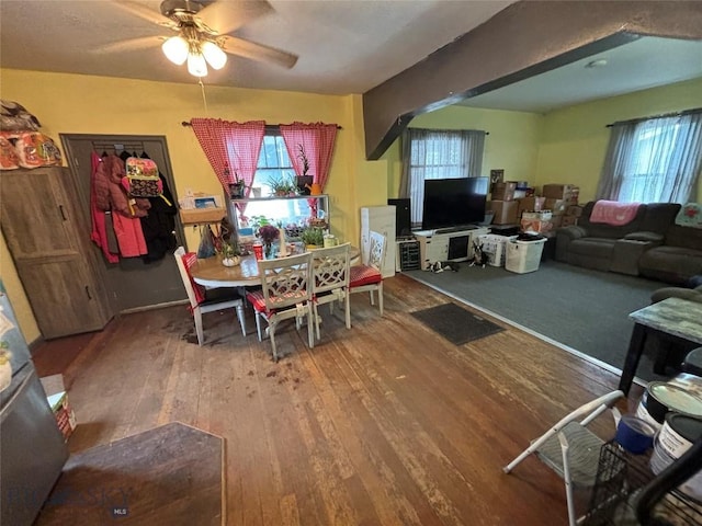 dining space with wood-type flooring and ceiling fan