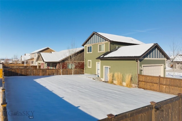 rear view of property with a garage