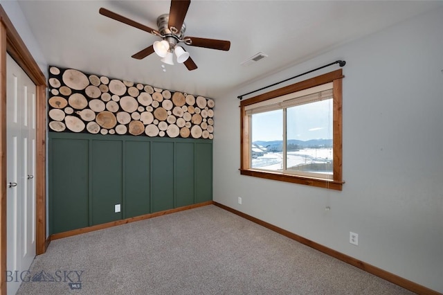 carpeted empty room with ceiling fan