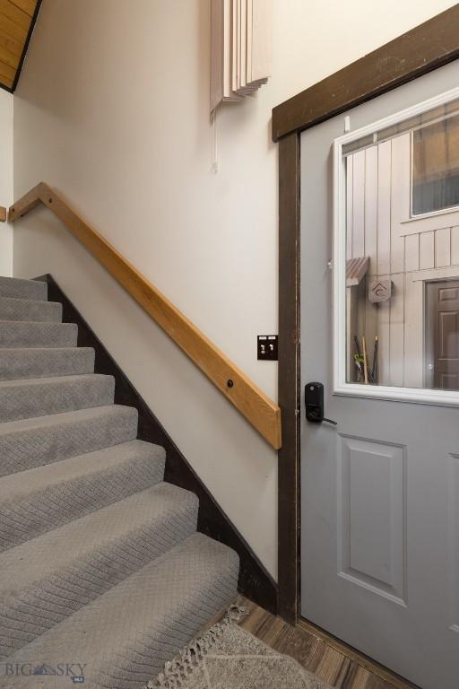 stairway featuring hardwood / wood-style flooring