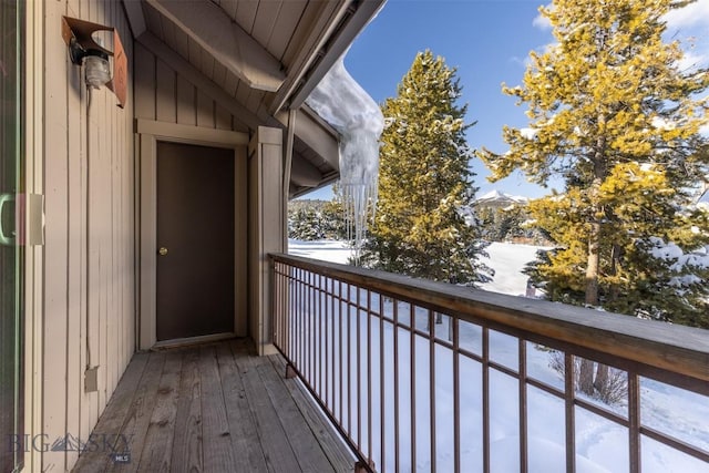 view of snow covered back of property