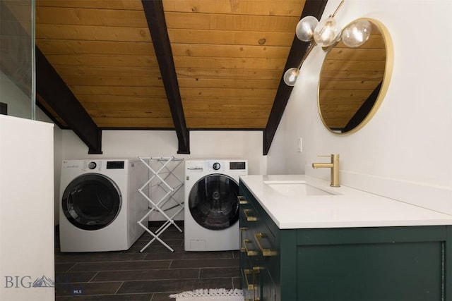 laundry area featuring washer and clothes dryer, sink, and wood ceiling