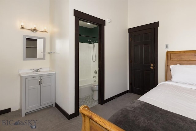 carpeted bedroom featuring sink and ensuite bathroom