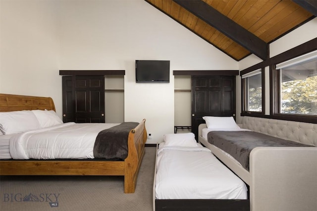 carpeted bedroom featuring lofted ceiling with beams and wooden ceiling