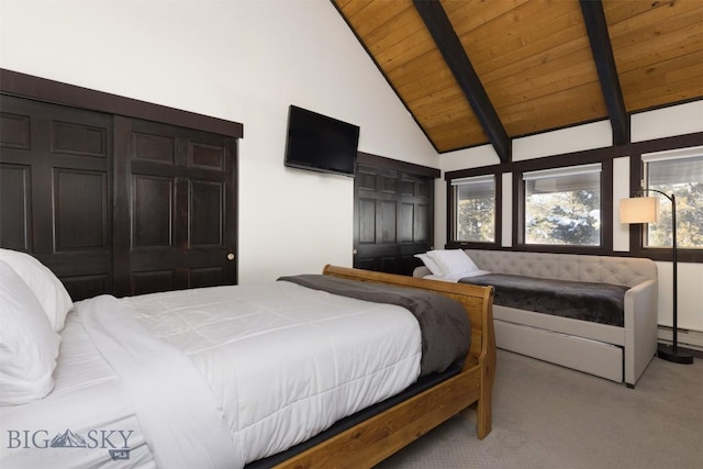 carpeted bedroom with lofted ceiling with beams, a baseboard heating unit, and wooden ceiling