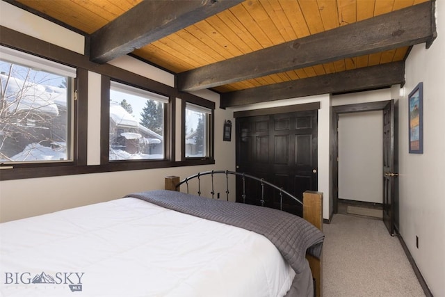 carpeted bedroom with beamed ceiling and wooden ceiling