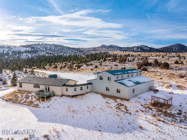 snowy aerial view featuring a mountain view