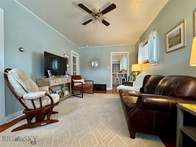 living room with ceiling fan and light hardwood / wood-style floors