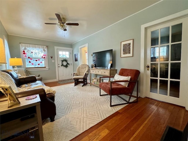 living area featuring hardwood / wood-style floors and ceiling fan