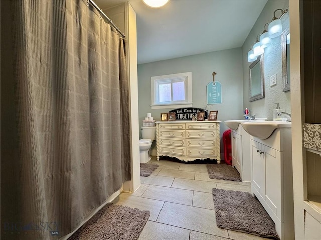 bathroom with vanity, tile patterned floors, and toilet