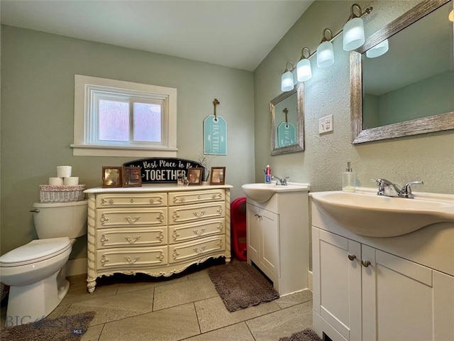 bathroom featuring tile patterned floors, vanity, and toilet