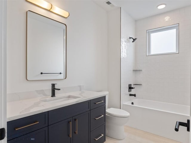 full bathroom with vanity, tile patterned floors, toilet, and tiled shower / bath