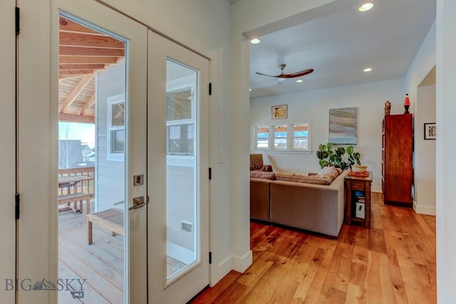 entryway with french doors, ceiling fan, and light wood-type flooring