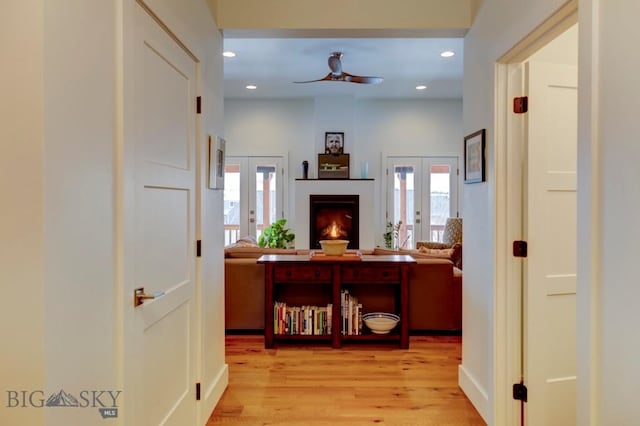 hallway with french doors and light wood-type flooring