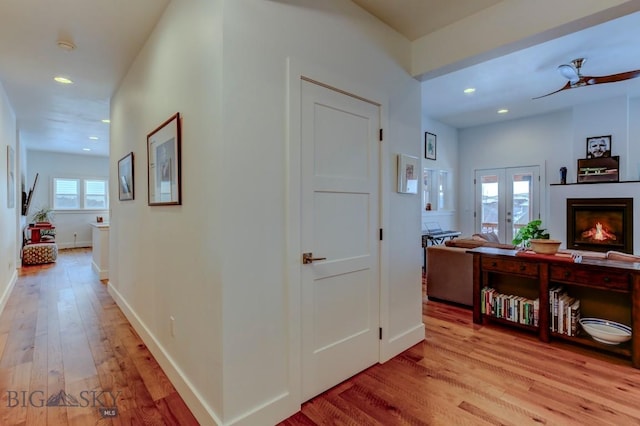 hallway featuring light hardwood / wood-style flooring and french doors