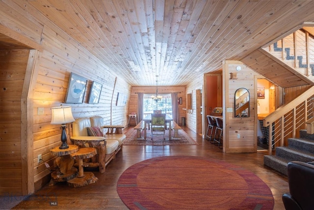 interior space with a notable chandelier, wood walls, hardwood / wood-style floors, and wooden ceiling