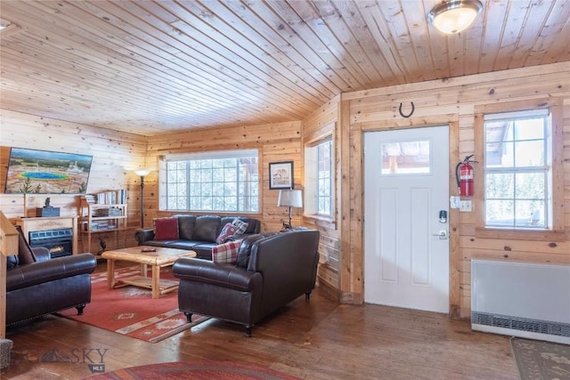 living room featuring wood-type flooring, wood ceiling, and wood walls