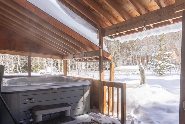 snow covered deck with a hot tub