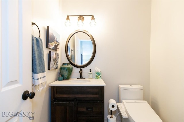 bathroom featuring vanity and toilet