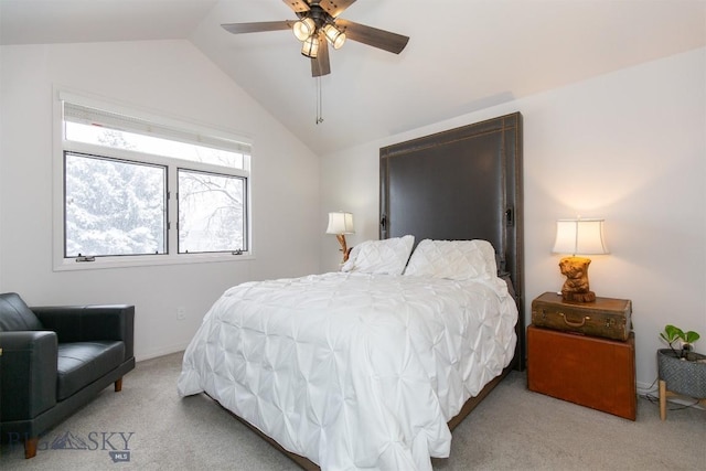 carpeted bedroom with ceiling fan and vaulted ceiling