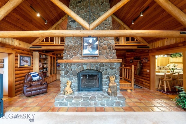 living room with wood ceiling, high vaulted ceiling, a fireplace, track lighting, and log walls