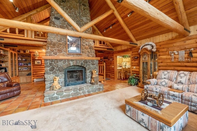 living room with beamed ceiling, a stone fireplace, log walls, and high vaulted ceiling