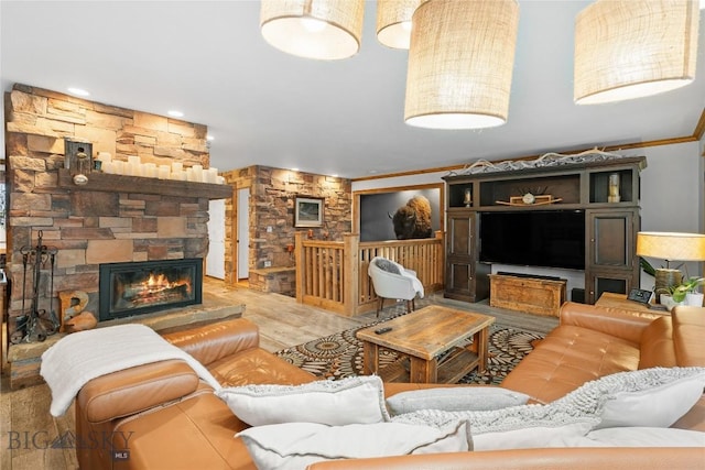 living room with hardwood / wood-style floors, a fireplace, and ornamental molding