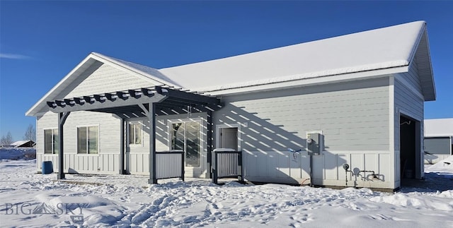 view of snow covered exterior featuring a pergola