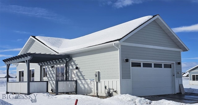 view of snowy exterior featuring a pergola