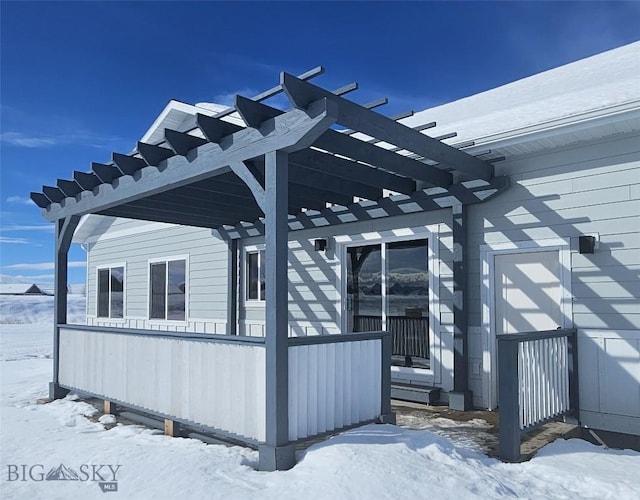 view of snow covered exterior featuring a pergola