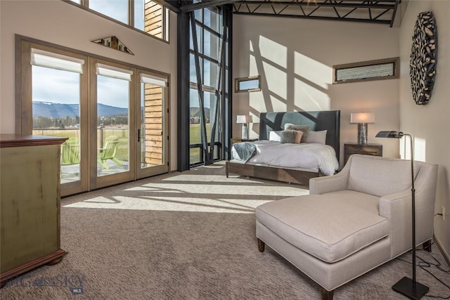 2174 Little Coyote Rd, Big Sky, MT 59716 - carpeted bedroom with access to outside, a high ceiling, and a mountain view