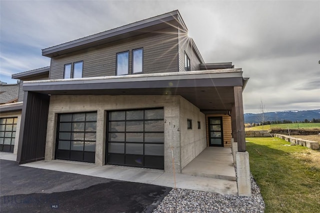 2174 Little Coyote Rd, Big Sky, MT 59716 - view of home's exterior featuring an attached garage, a yard, and a mountain view