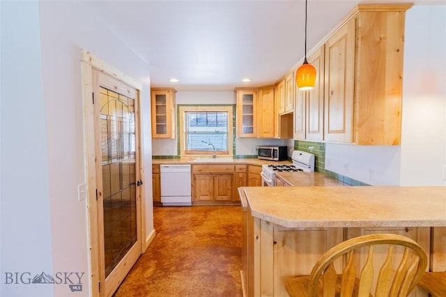 kitchen featuring sink, hanging light fixtures, light brown cabinets, kitchen peninsula, and white appliances