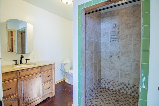 full bath featuring baseboards, toilet, a stall shower, and vanity