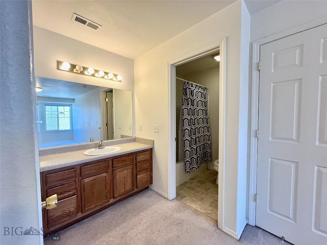 full bathroom with vanity, toilet, and shower / tub combo with curtain