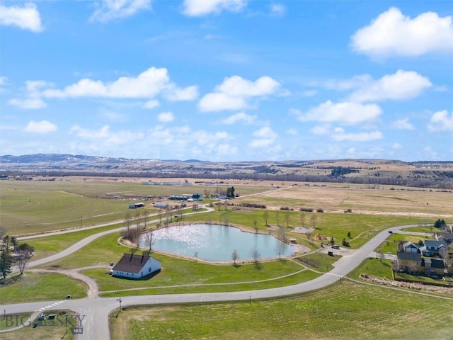 aerial view featuring a rural view and a water and mountain view