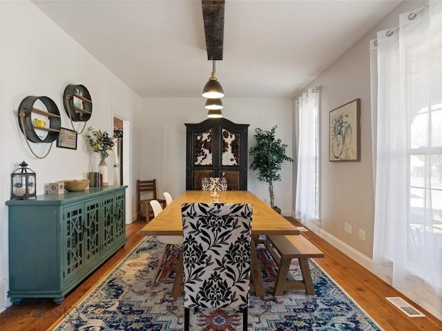 dining space with hardwood / wood-style flooring