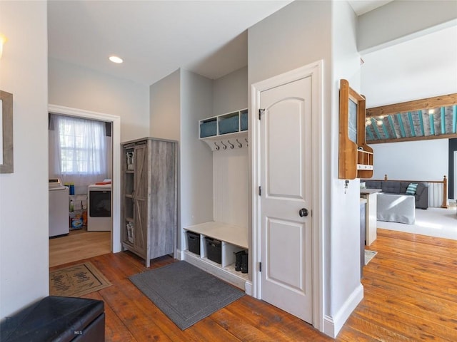 mudroom with hardwood / wood-style flooring and washing machine and dryer